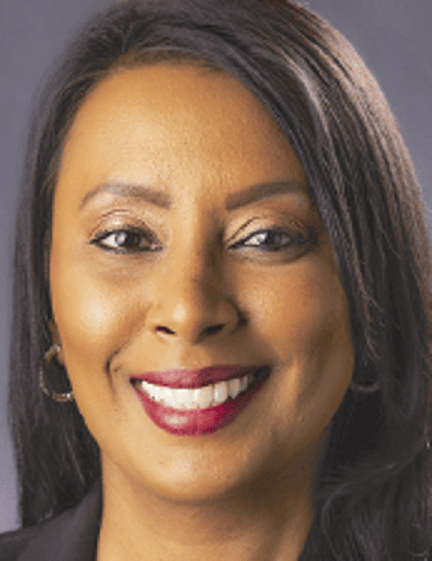 a close up of a woman who is smiling and looking at the camera