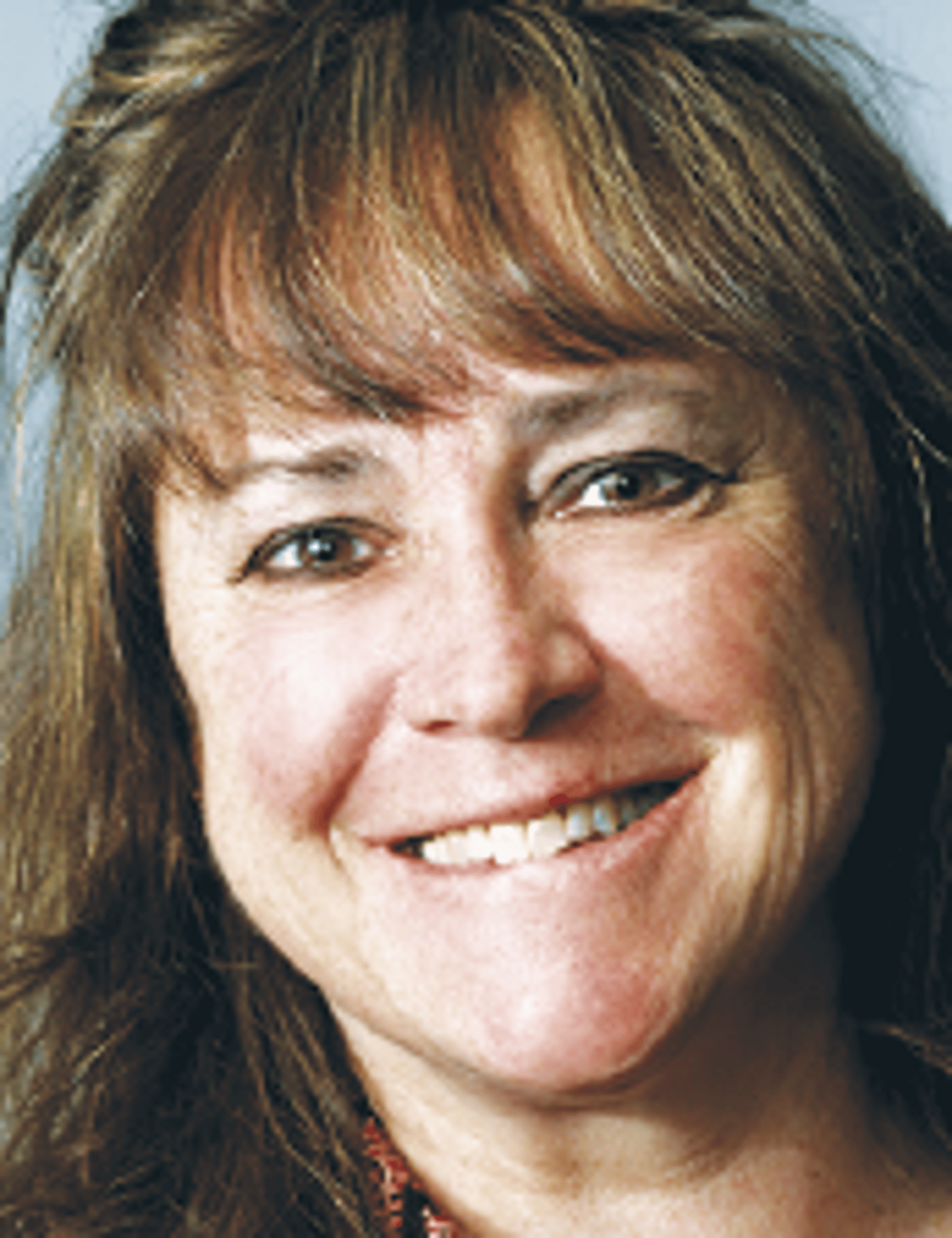 a close up of a woman who is smiling at the camera