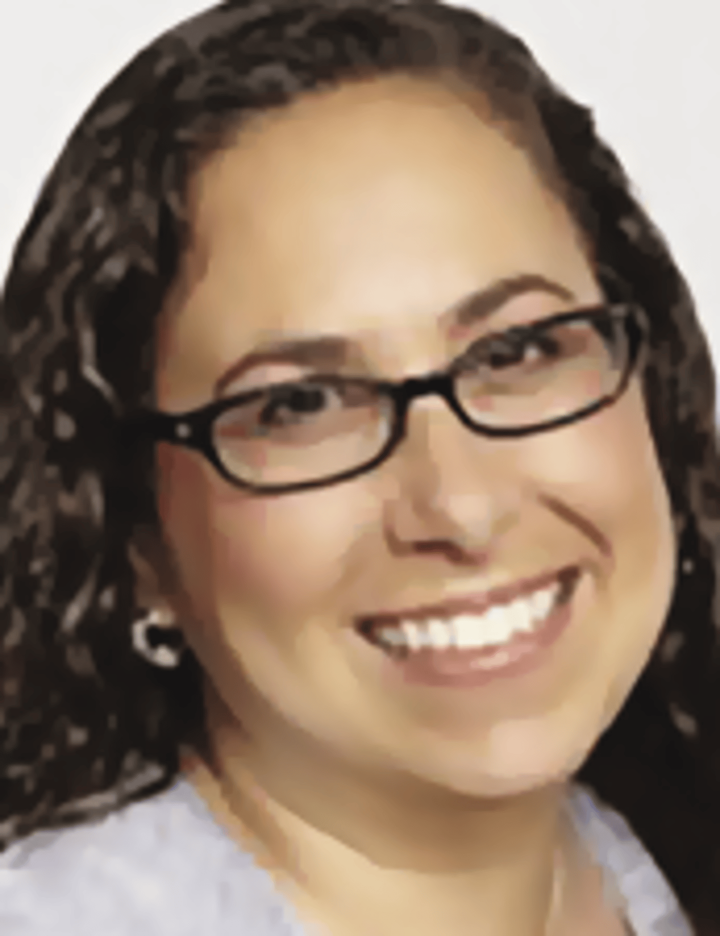 a woman wearing glasses and smiling at the camera