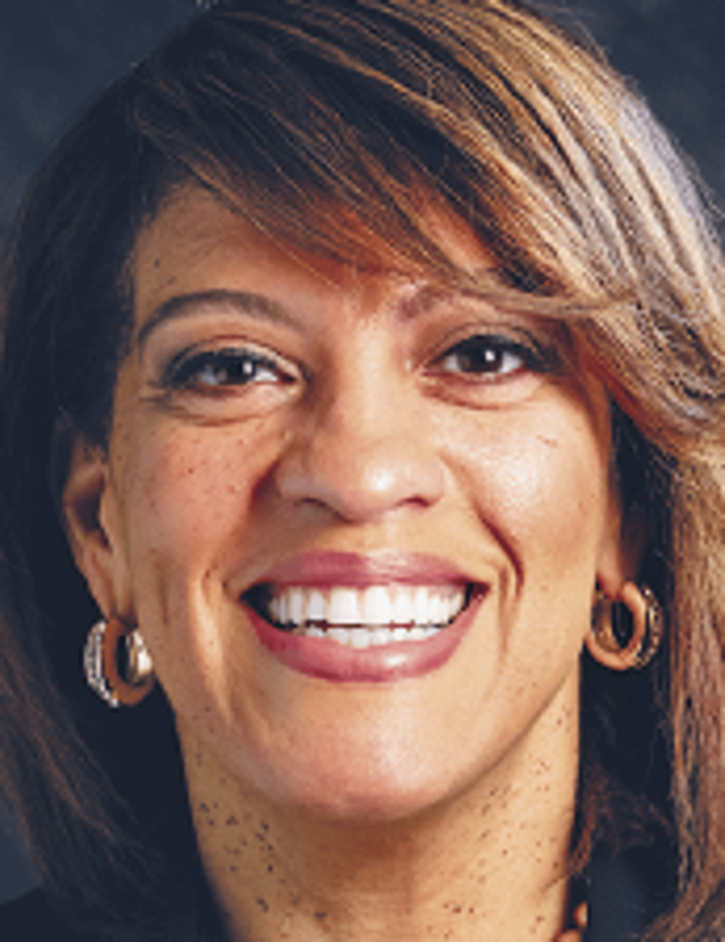 a close up of a woman who is smiling at the camera