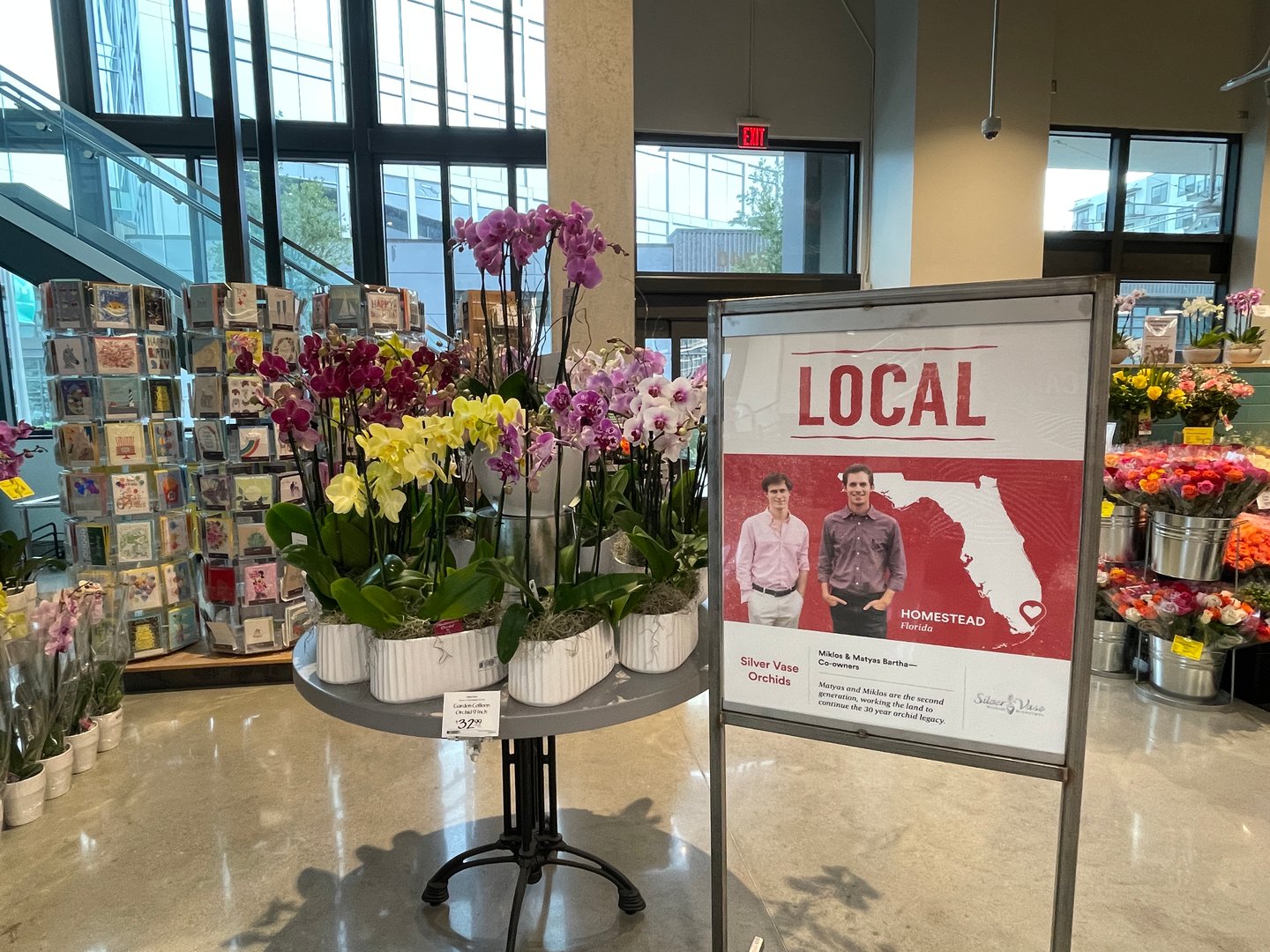 a vase with flowers in front of a store