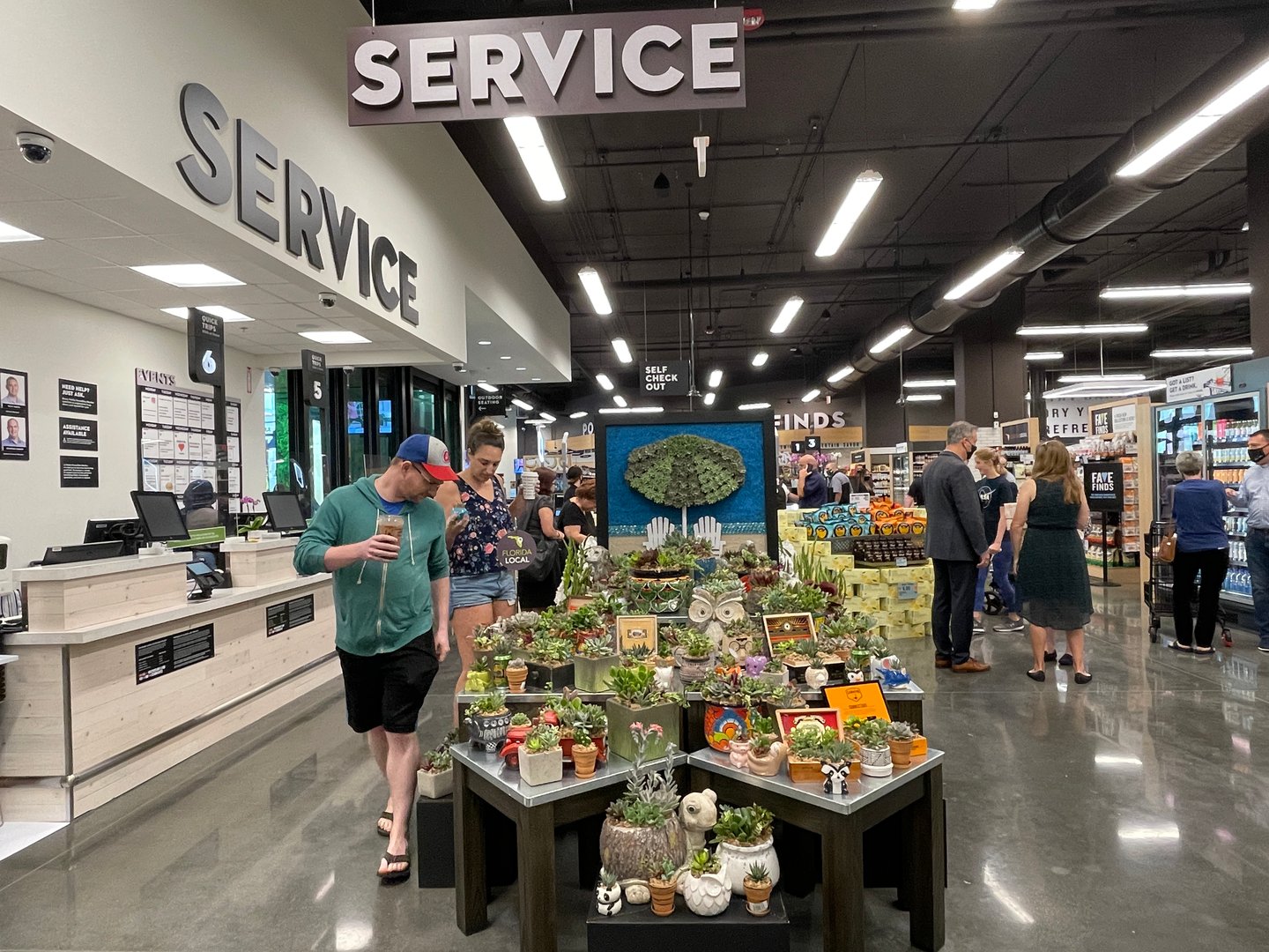 a group of people standing in front of a store