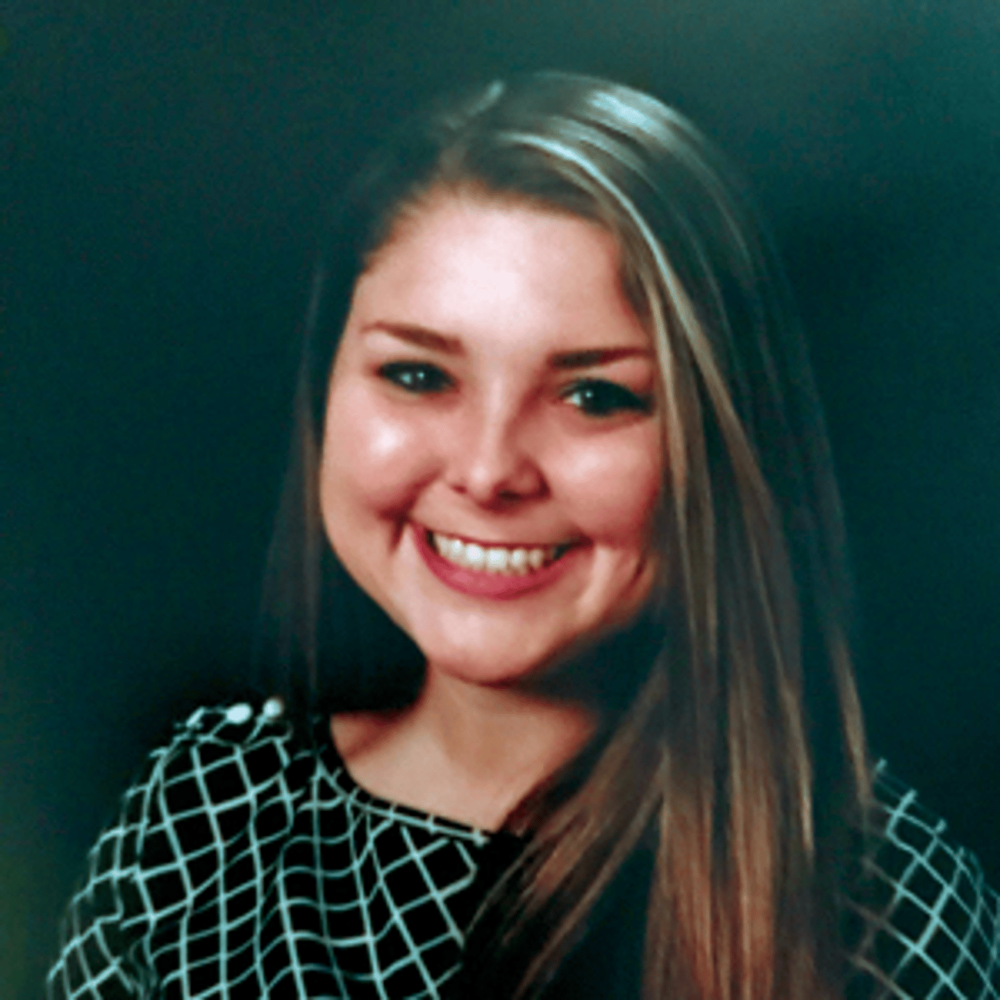 a young girl who is smiling at the camera