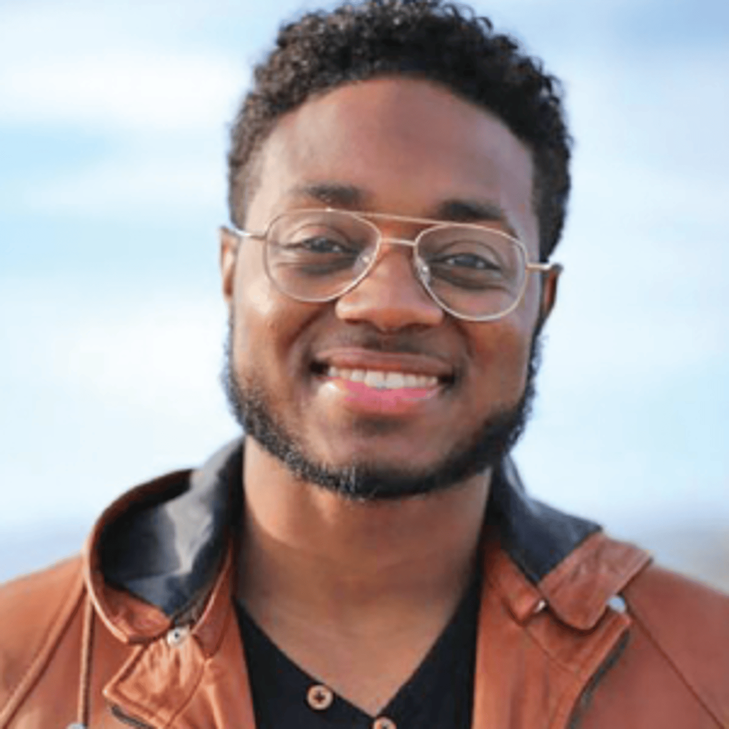Brandon Hill wearing glasses and smiling at the camera