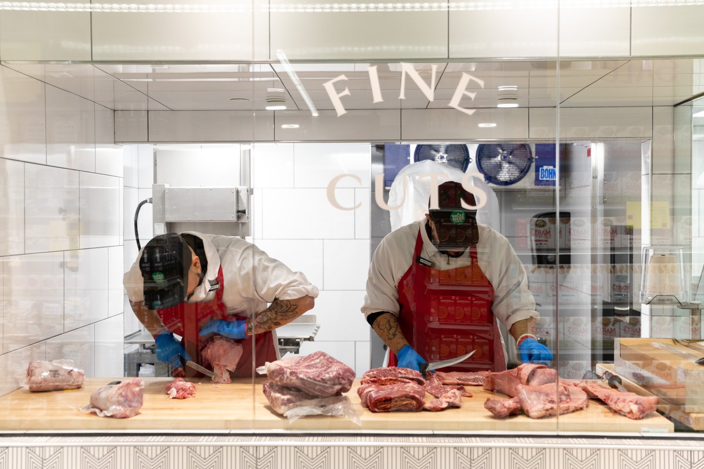 Customers can watch butchers at work in the meat department.