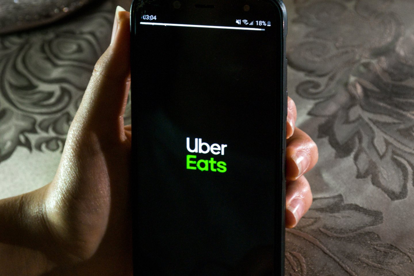 Uber Eats App in Hand Main Image