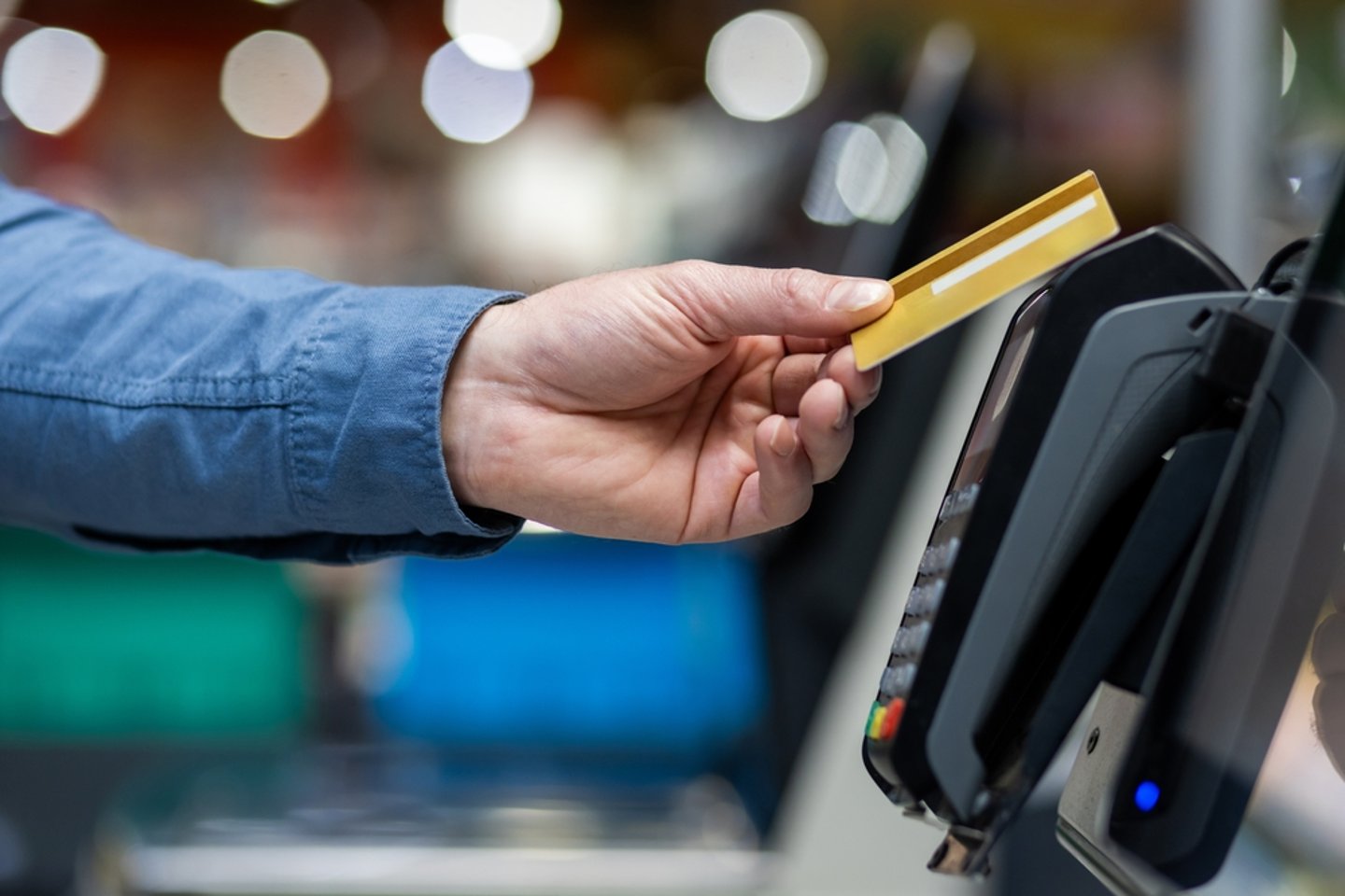 Man Paying With Credit Card in Supermarket Main Image