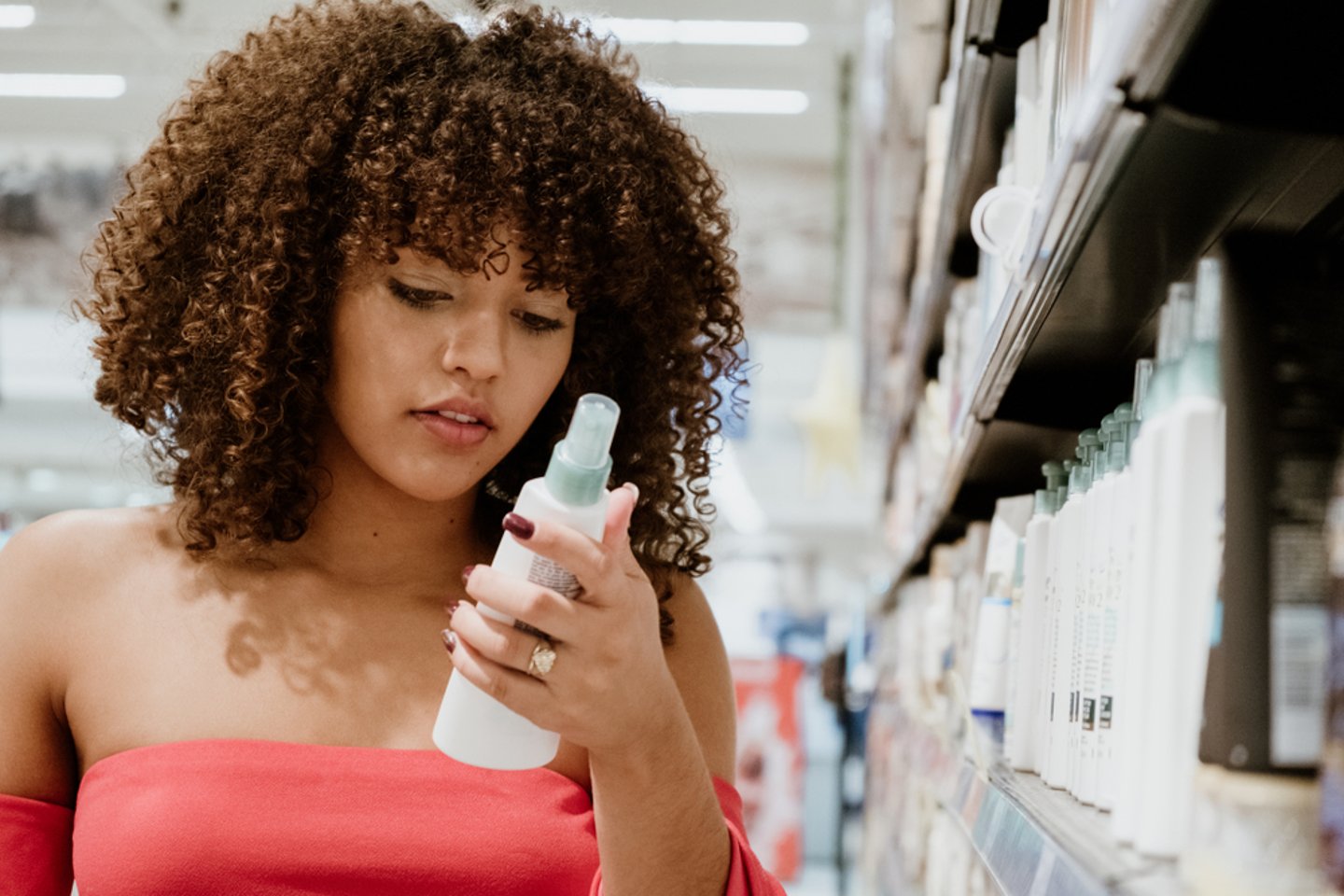 Woman Looking at Beauty Product Main Image