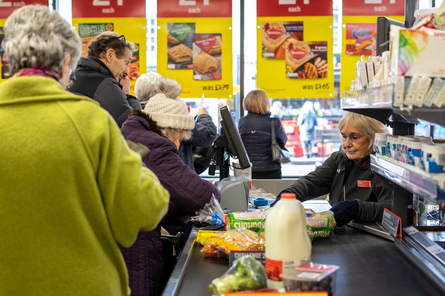 02/05/2020 Chichester, West sussex, UK A Supermarket cashier scanning items at the checkout taking items from the conveyor belt that has products on; Shutterstock ID 1637268079